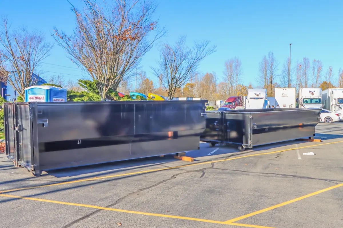 Professional dumpster rental service with roll-off container on residential driveway in Yarmouth